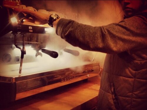Hadassah Wilson at her machine. Above, competing at the Big Eastern barista competition. (Photos: Courtesy Hadassah Wilson.)