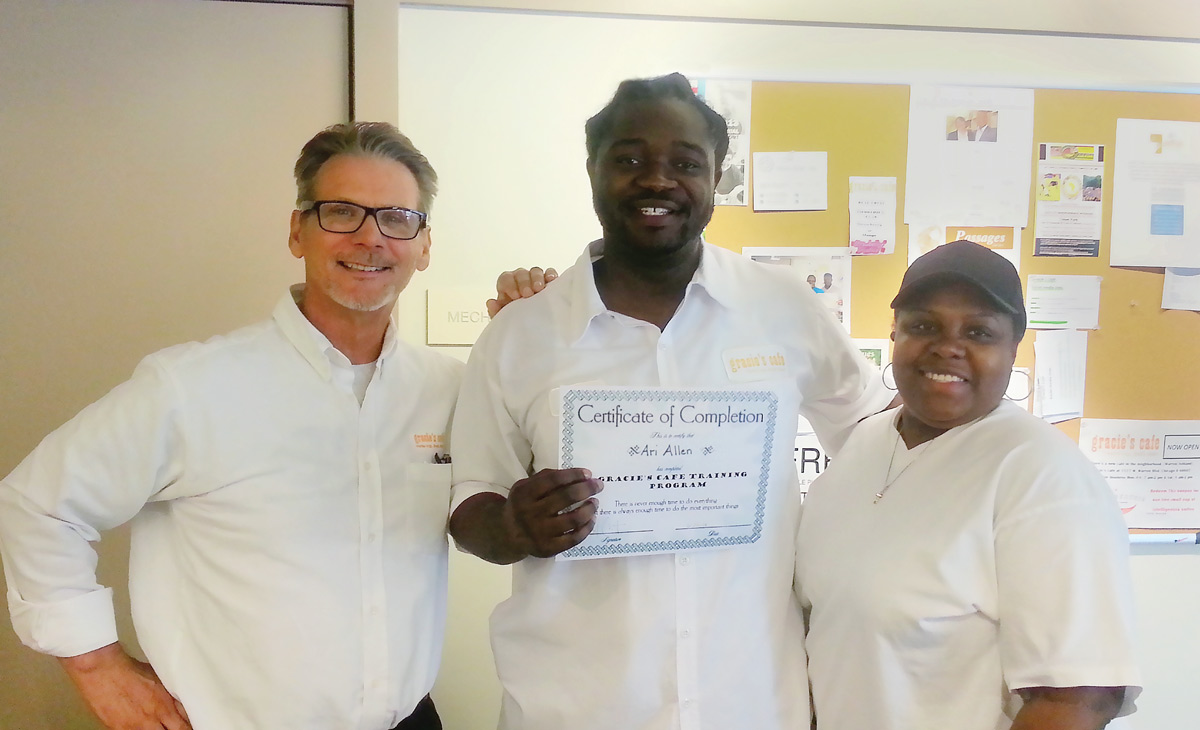 Mike Ellert, the founder of Gracie's Café, with recent graduate Ari Allen. (Photo: courtesy Gracie's Café.)