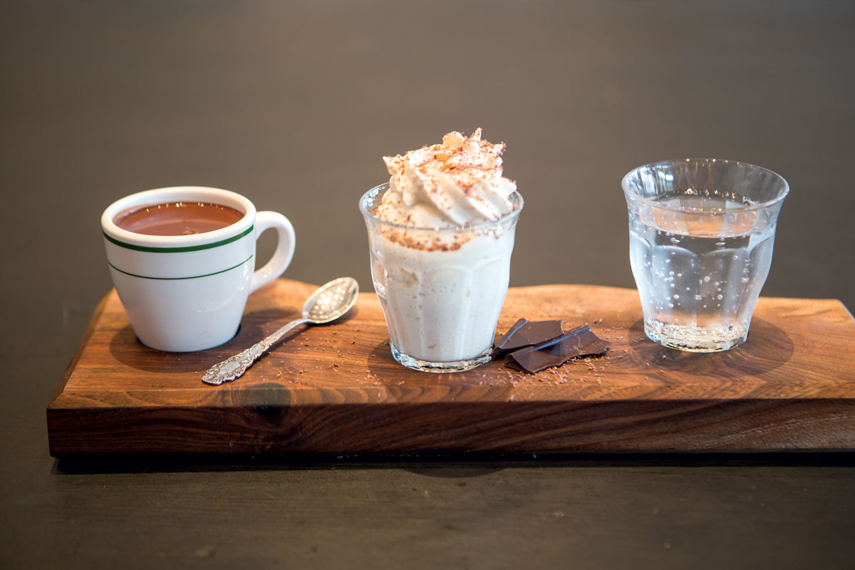 A pairing trio with seltzer, whipped cream, and dark drinking chocolate.